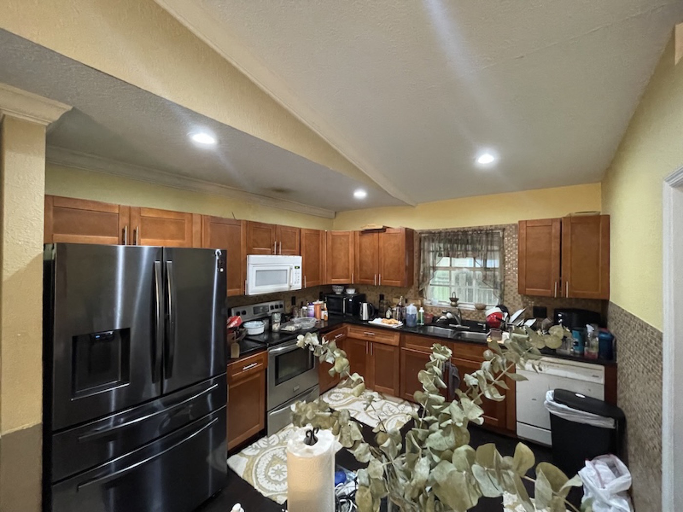 Dated wood-cabinet kitchen with brown walls before BiggerEquity purchase