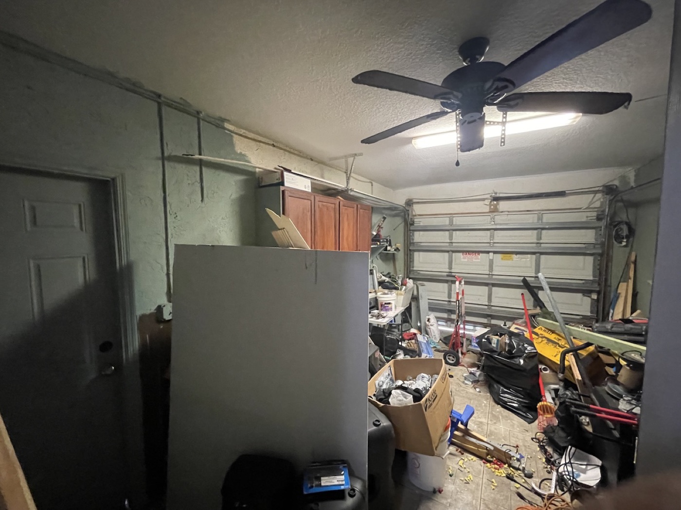 Garage packed with junk, tools, and storage clutter before BiggerEquity purchase